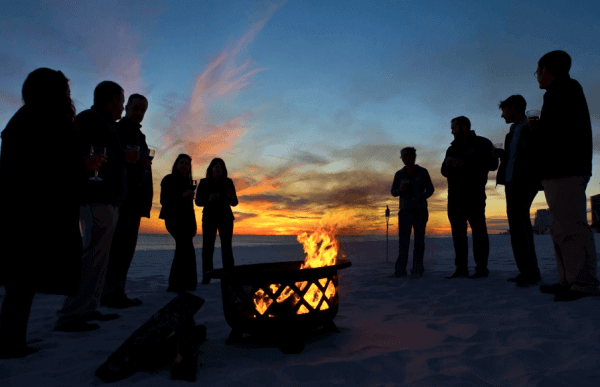 people gathering near bonfire