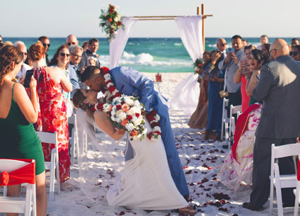 Bride and groom kiss at their beach ceremony in Destin, FL
