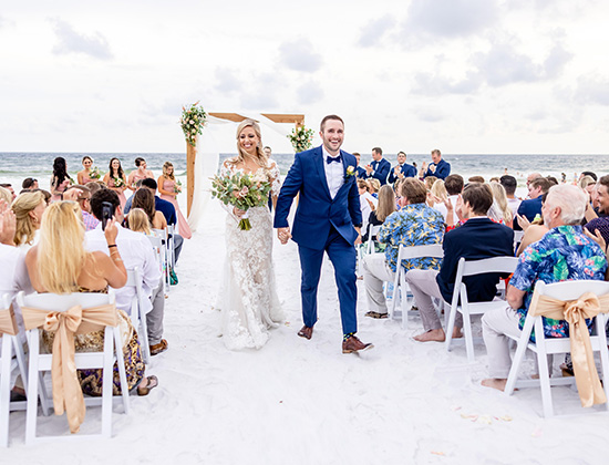 Couple walking down the aisle at their Destin beach wedding