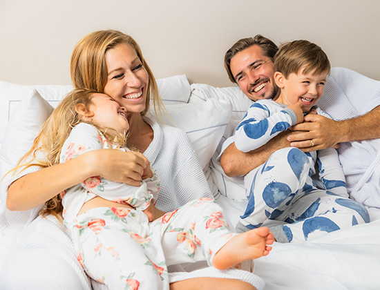 family on vacation cuddling in bed