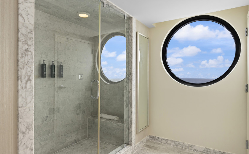 Tiled resort bathroom with a round window