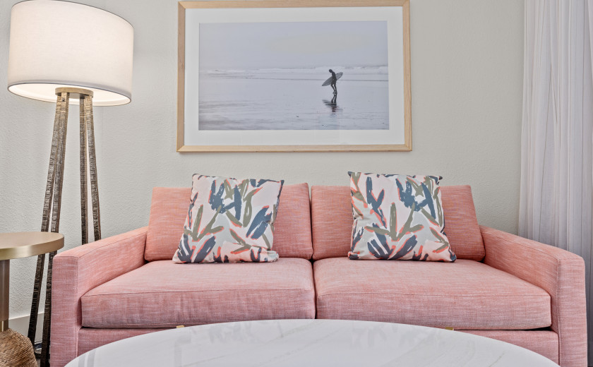 Florida Hotel living room featuring a large pink couch and marble coffee table