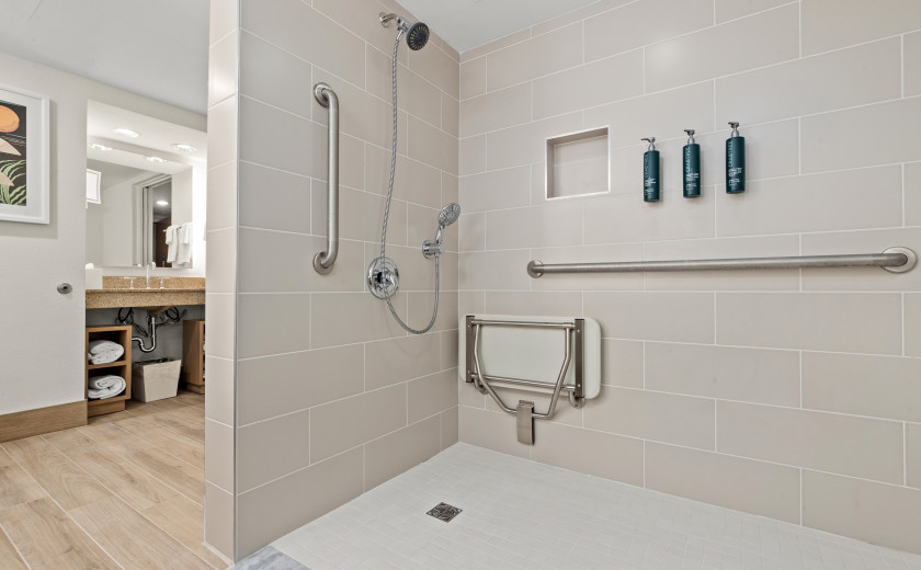 pink tiled shower in a hotel suite bathroom